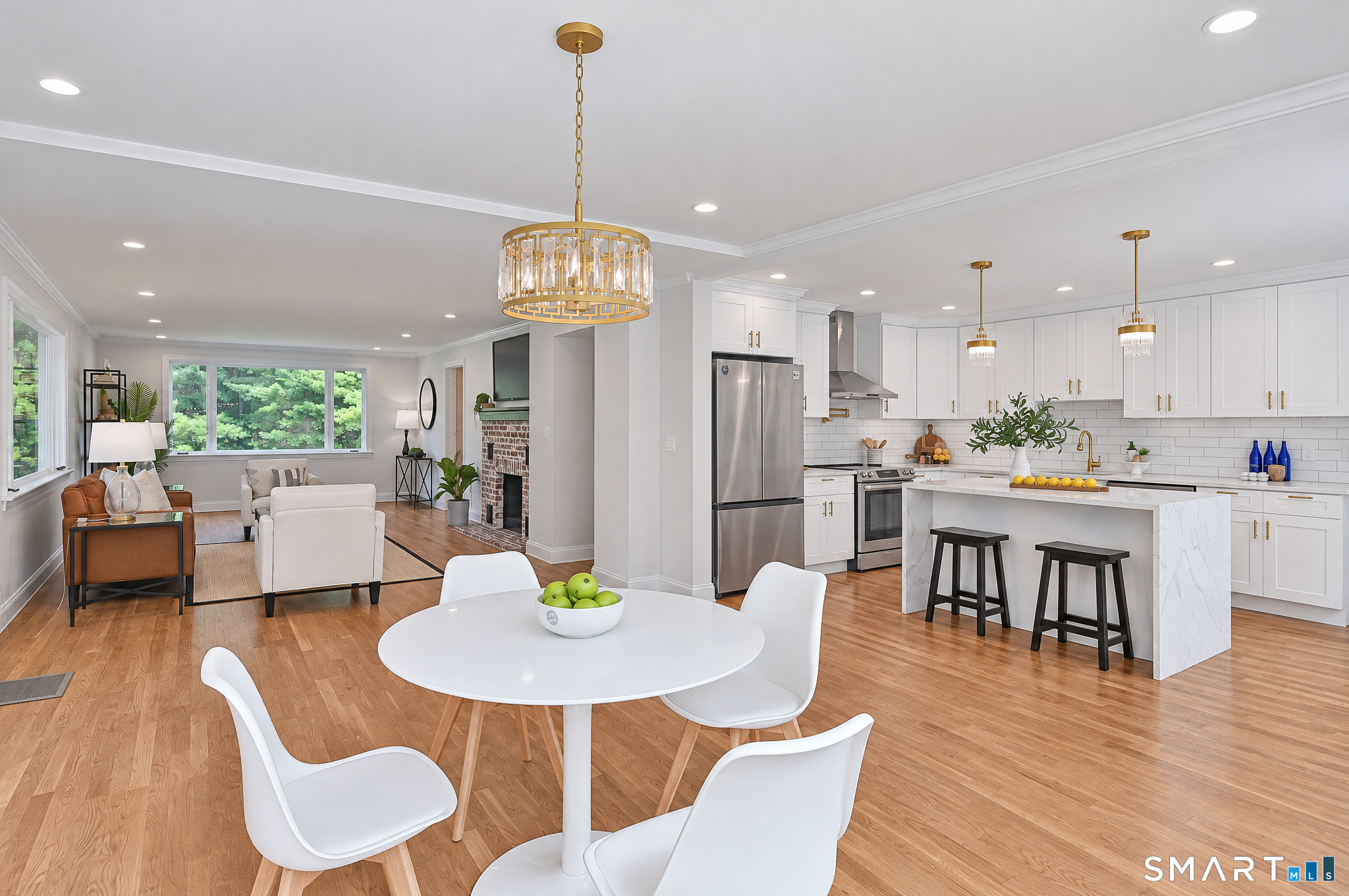 34 Rimmon Road Woodbridge, CT 06525 - Photo 10 of 40 Open-concept kitchen and dining area with hardwood floors and abundant natural light.