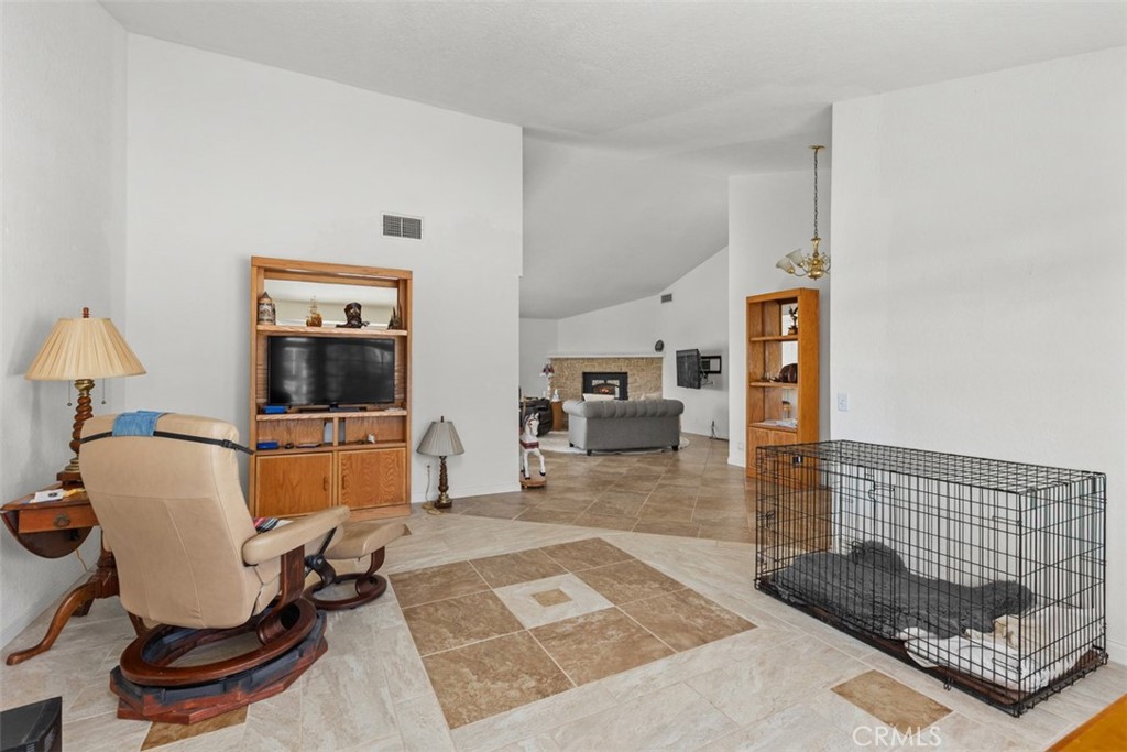 1765 Armadale Road Fallbrook, CA 92028 - Photo 11 of 45 a living room with furniture a flat screen tv and a table