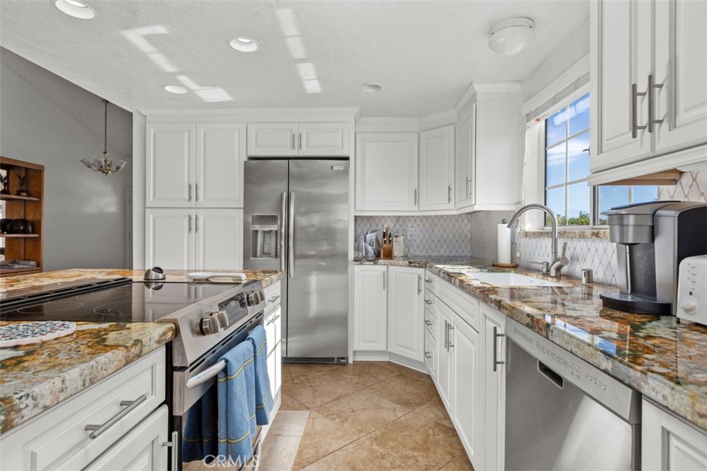 1765 Armadale Road Fallbrook, CA 92028 - Photo 17 of 45 a kitchen with stainless steel appliances granite countertop a sink stove and refrigerator