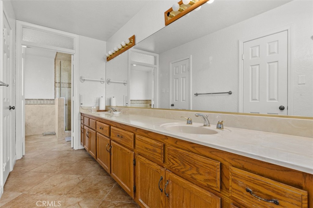 1765 Armadale Road Fallbrook, CA 92028 - Photo 28 of 45 a spacious bathroom with a sink and a mirror