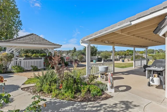 a view of a patio with a table and chairs
