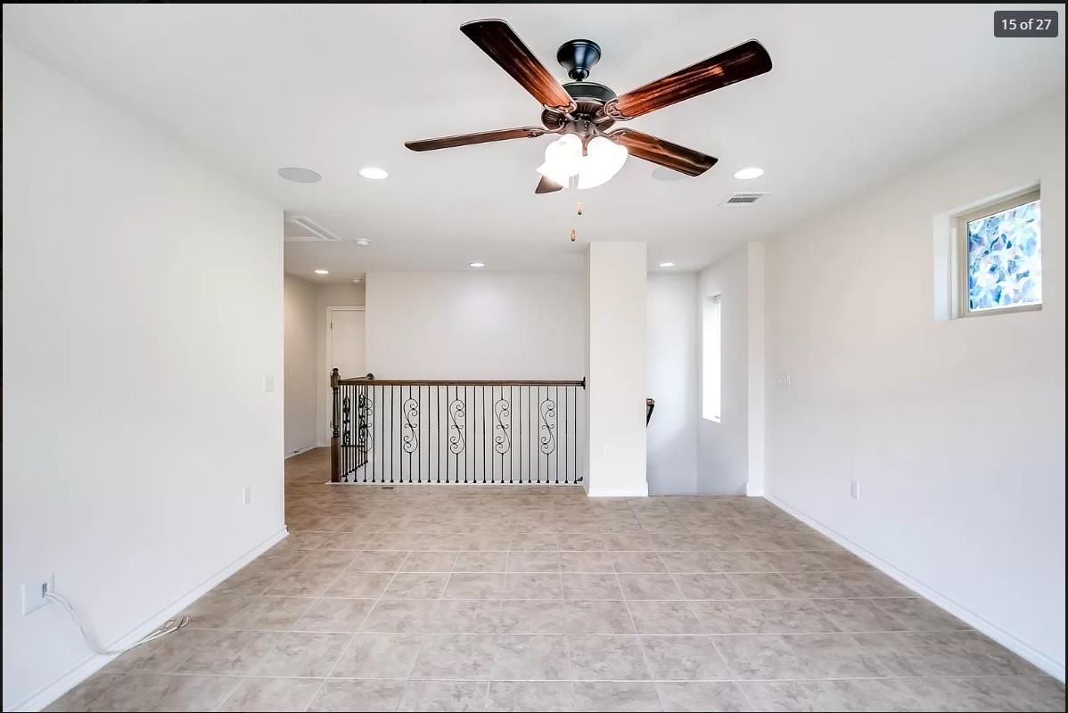 14215 McCoy Loop Austin, TX 78717 - Photo 12 of 27 Spacious living area featuring neutral-toned tile flooring, a dark wood-finish ceiling fan with integrated lighting, and recessed ceiling lights