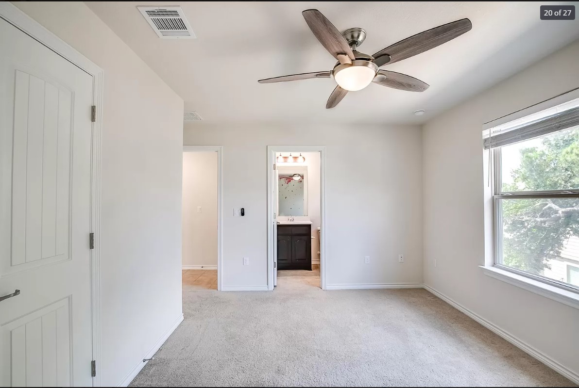 14215 McCoy Loop Austin, TX 78717 - Photo 17 of 27 Carpeted room featuring a ceiling fan with light fixture, natural light from a double-hung window, and white interior doors
