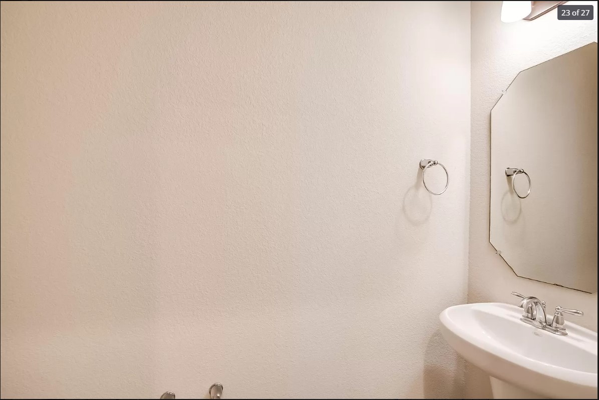 14215 McCoy Loop Austin, TX 78717 - Photo 20 of 27 Pedestal sink with chrome fixtures and an octagonal wall mirror