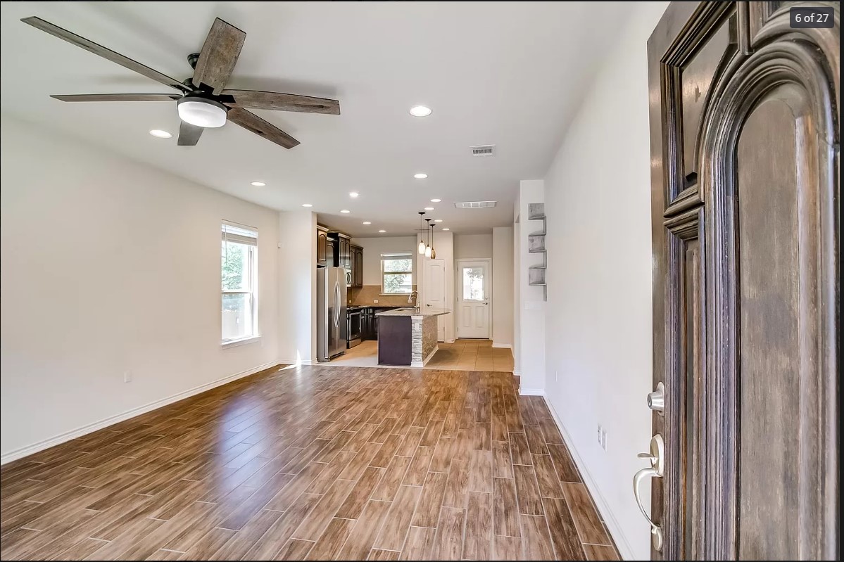 14215 McCoy Loop Austin, TX 78717 - Photo 24 of 27 Open-concept living area featuring wood-finish tile flooring and recessed lighting