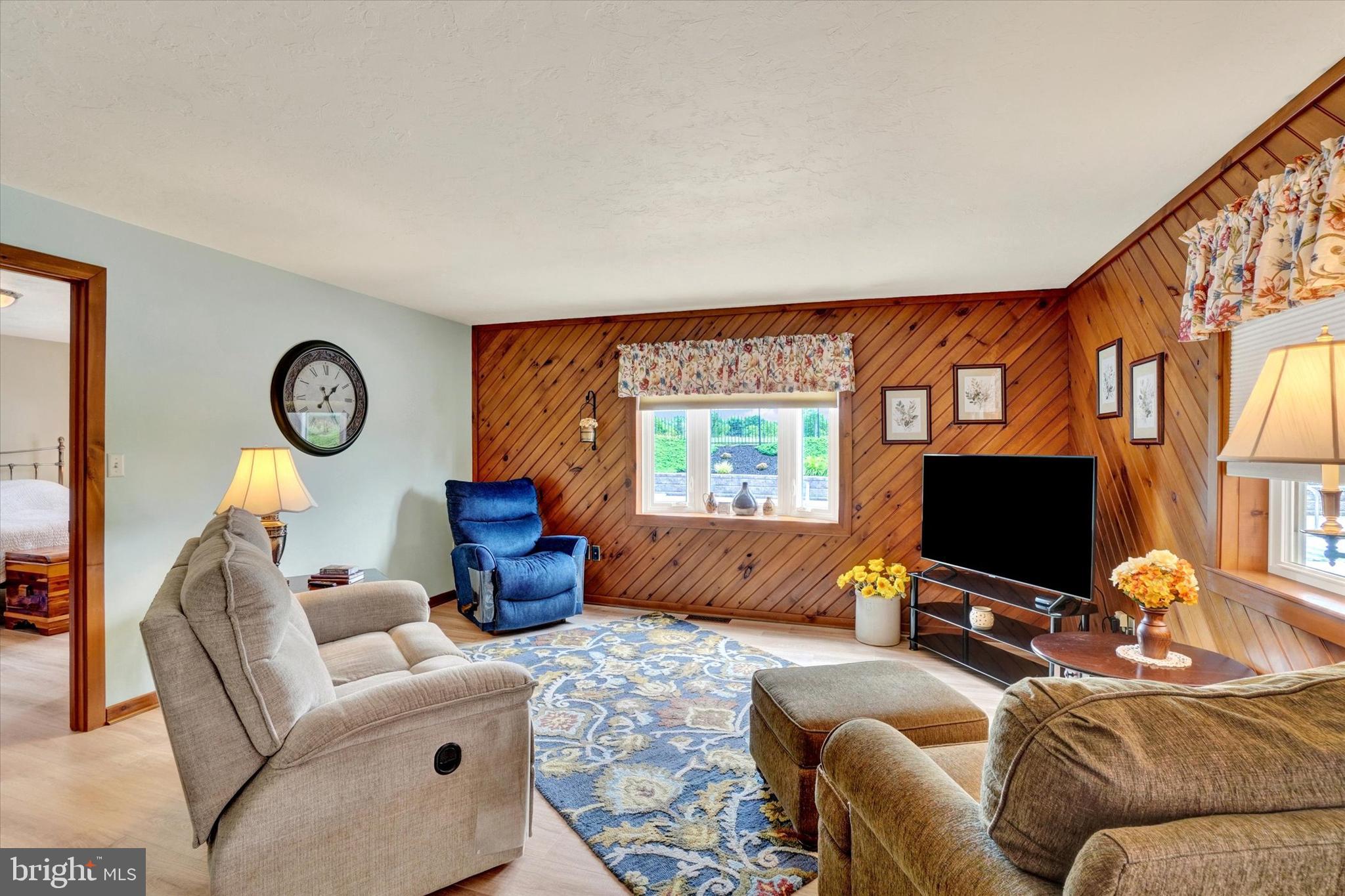 285 South Main Street Mount Wolf, PA 17347 - Photo 13 of 34 a living room with furniture a flat screen tv and a window