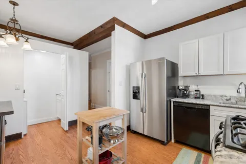 a kitchen with a refrigerator and a stove top oven