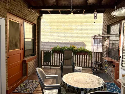 a view of a balcony with table and chairs
