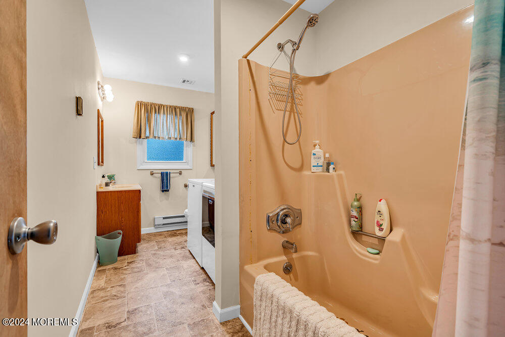 402 A Mantoloking Road Brick, NJ 08723 - Photo 14 of 51 a bathroom with a tub sink and mirror