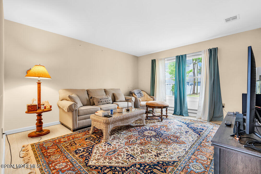 402 A Mantoloking Road Brick, NJ 08723 - Photo 15 of 51 a living room with furniture and a flat screen tv