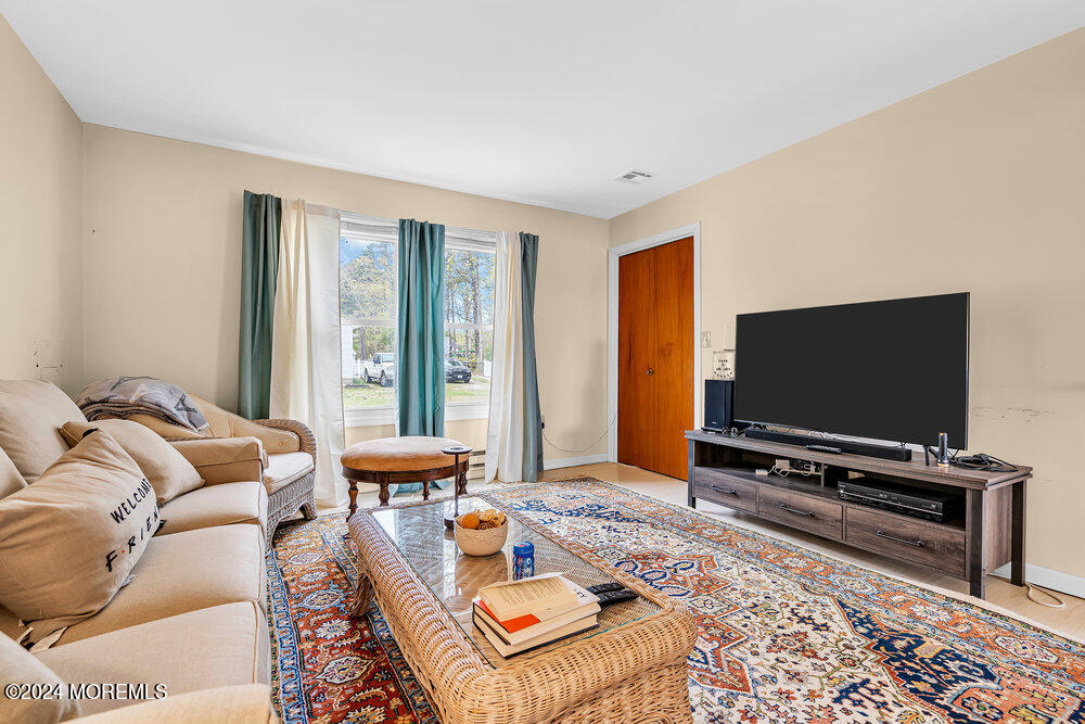 402 A Mantoloking Road Brick, NJ 08723 - Photo 16 of 51 a living room with furniture and a flat screen tv