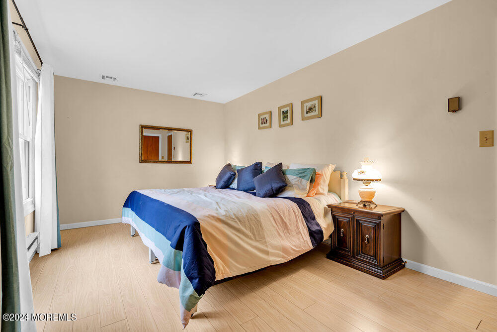 402 A Mantoloking Road Brick, NJ 08723 - Photo 17 of 51 a bedroom with a bed and lamp