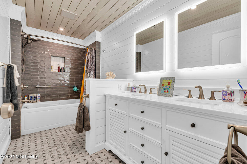 402 A Mantoloking Road Brick, NJ 08723 - Photo 20 of 51 a bathroom with a bathtub sink vanity and mirror