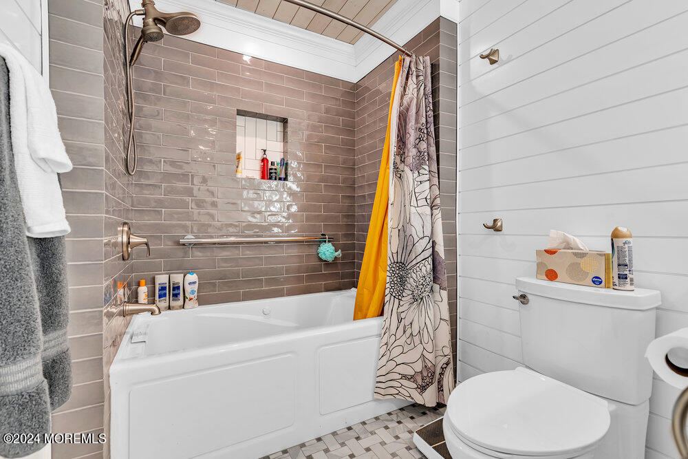 402 A Mantoloking Road Brick, NJ 08723 - Photo 21 of 51 a bathroom with a white toilet sitting next to a white tub