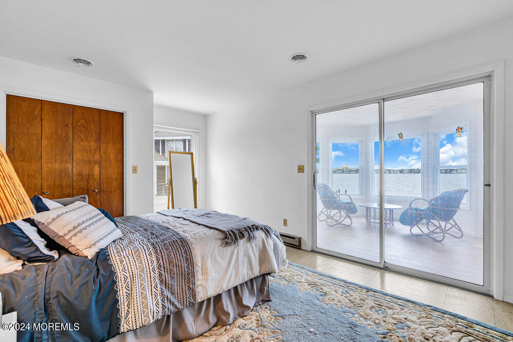 402 A Mantoloking Road Brick, NJ 08723 - Photo 24 of 51 a bedroom with a bed and a glass door