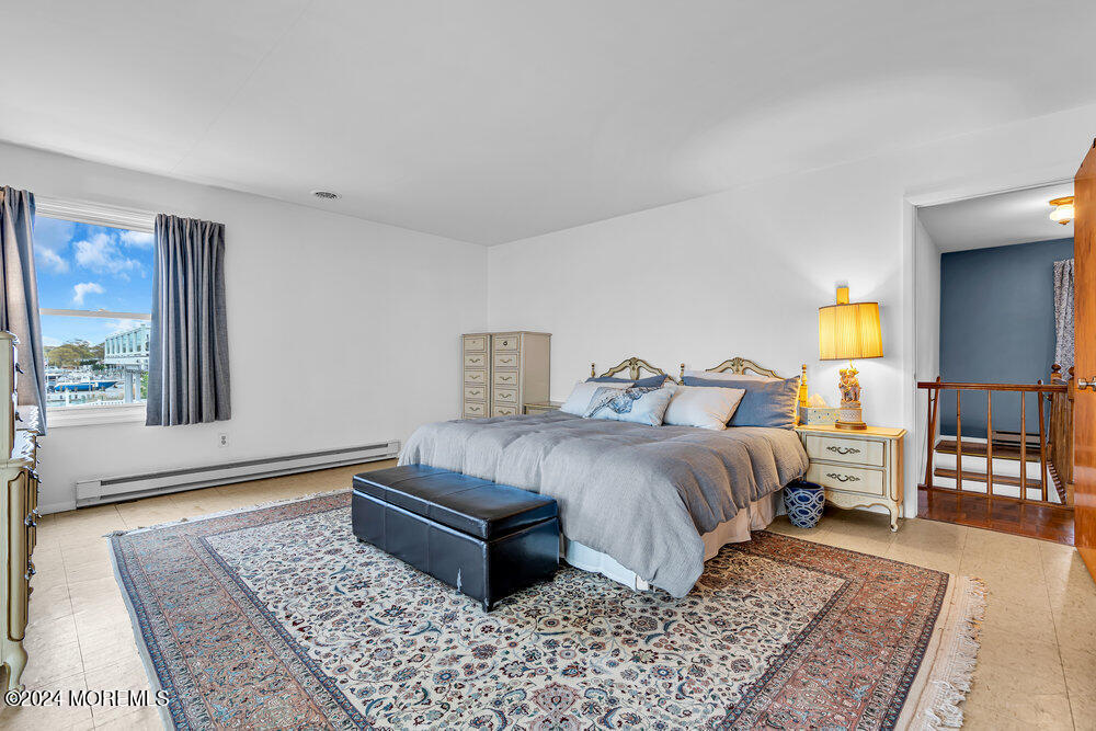 402 A Mantoloking Road Brick, NJ 08723 - Photo 27 of 51 a bedroom with a bed and wooden floor