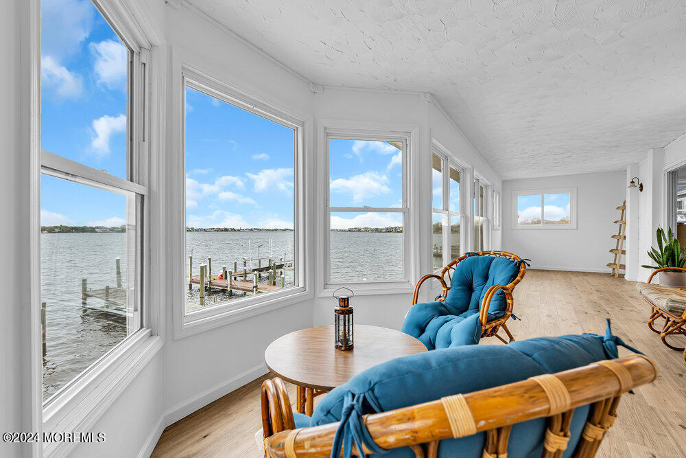 402 A Mantoloking Road Brick, NJ 08723 - Photo 32 of 51 a living room with furniture and a floor to ceiling window