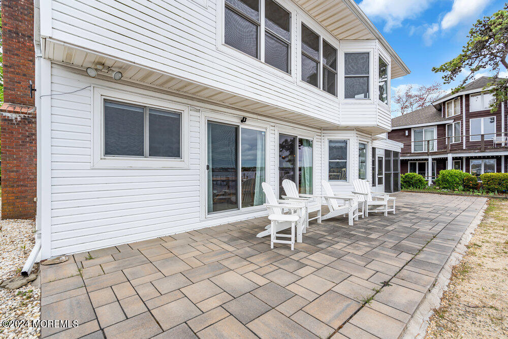 402 A Mantoloking Road Brick, NJ 08723 - Photo 41 of 51 a couple of lawn chairs sitting in front of a house