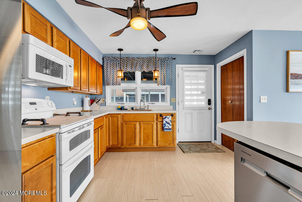 402 A Mantoloking Road Brick, NJ 08723 - Photo 9 of 51 a kitchen with stainless steel appliances granite countertop a stove and a sink
