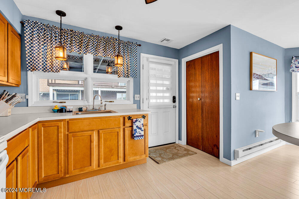 402 A Mantoloking Road Brick, NJ 08723 - Photo 10 of 51 a view of a kitchen with a sink and a refrigerator