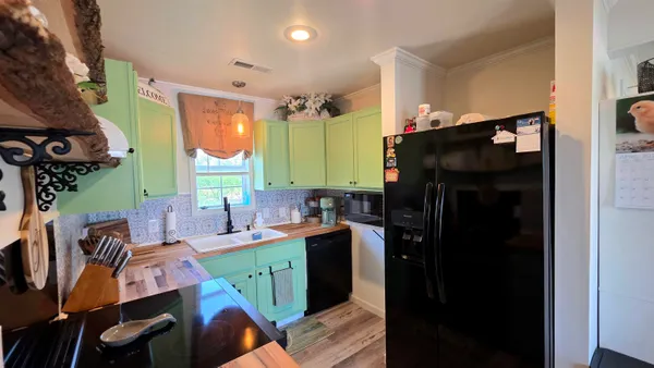 a kitchen with a sink appliances and cabinets