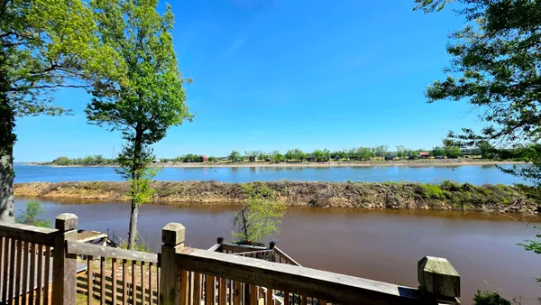 a view of a lake with houses in the background
