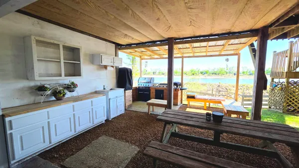 a room with wooden floor table and chairs
