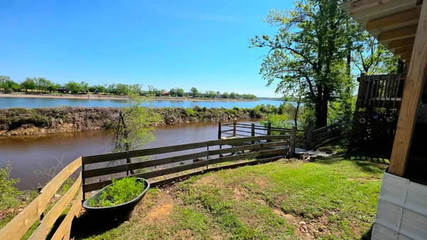 a view of backyard of house with green space