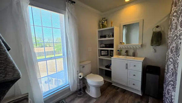 a bathroom with a toilet sink and mirror