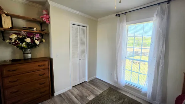 a view of hallway with wooden floor and chandelier