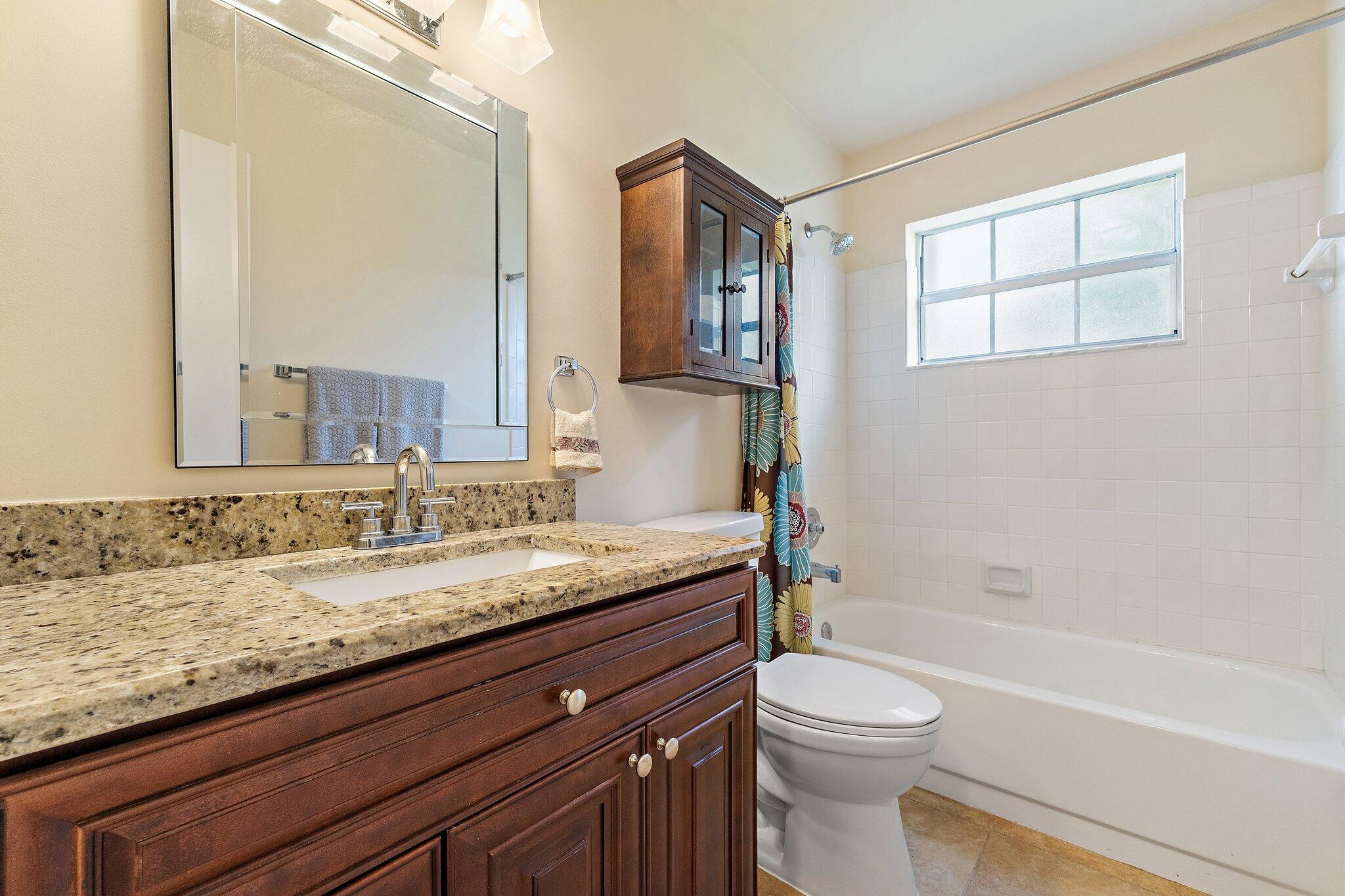 109 Doe Trail Jupiter, FL 33458 - Photo 19 of 26 a bathroom with a granite countertop sink toilet and shower