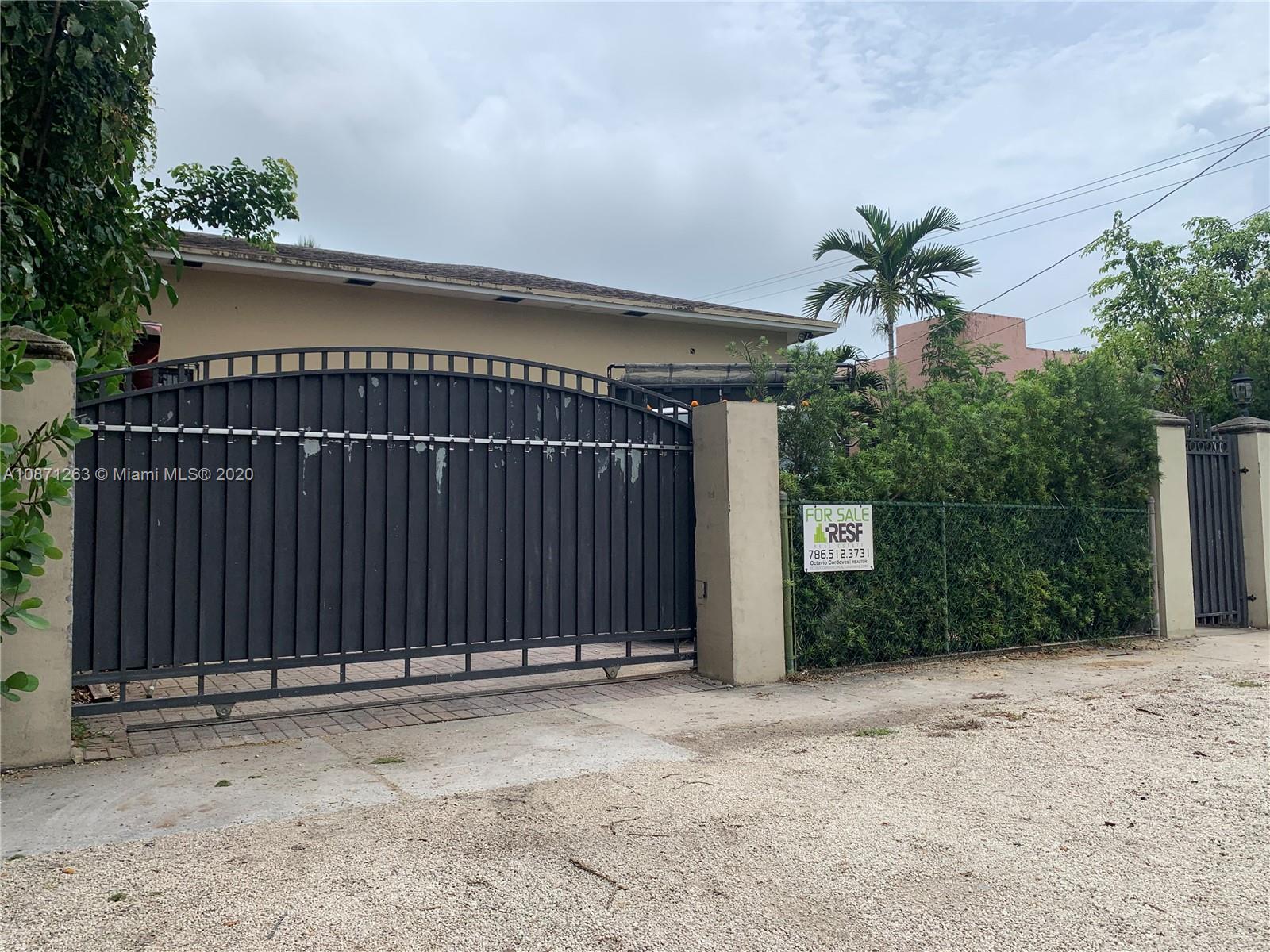105 Southwest 22nd Road Miami, FL 33129 - Photo 1 of 26 a view of a house with a backyard