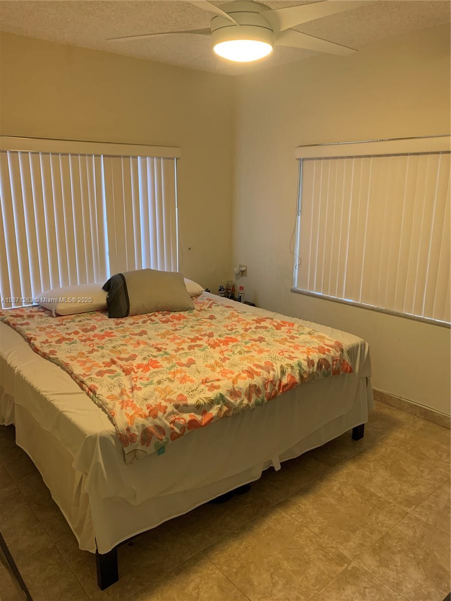 105 Southwest 22nd Road Miami, FL 33129 - Photo 13 of 26 a bedroom with a bed and a window