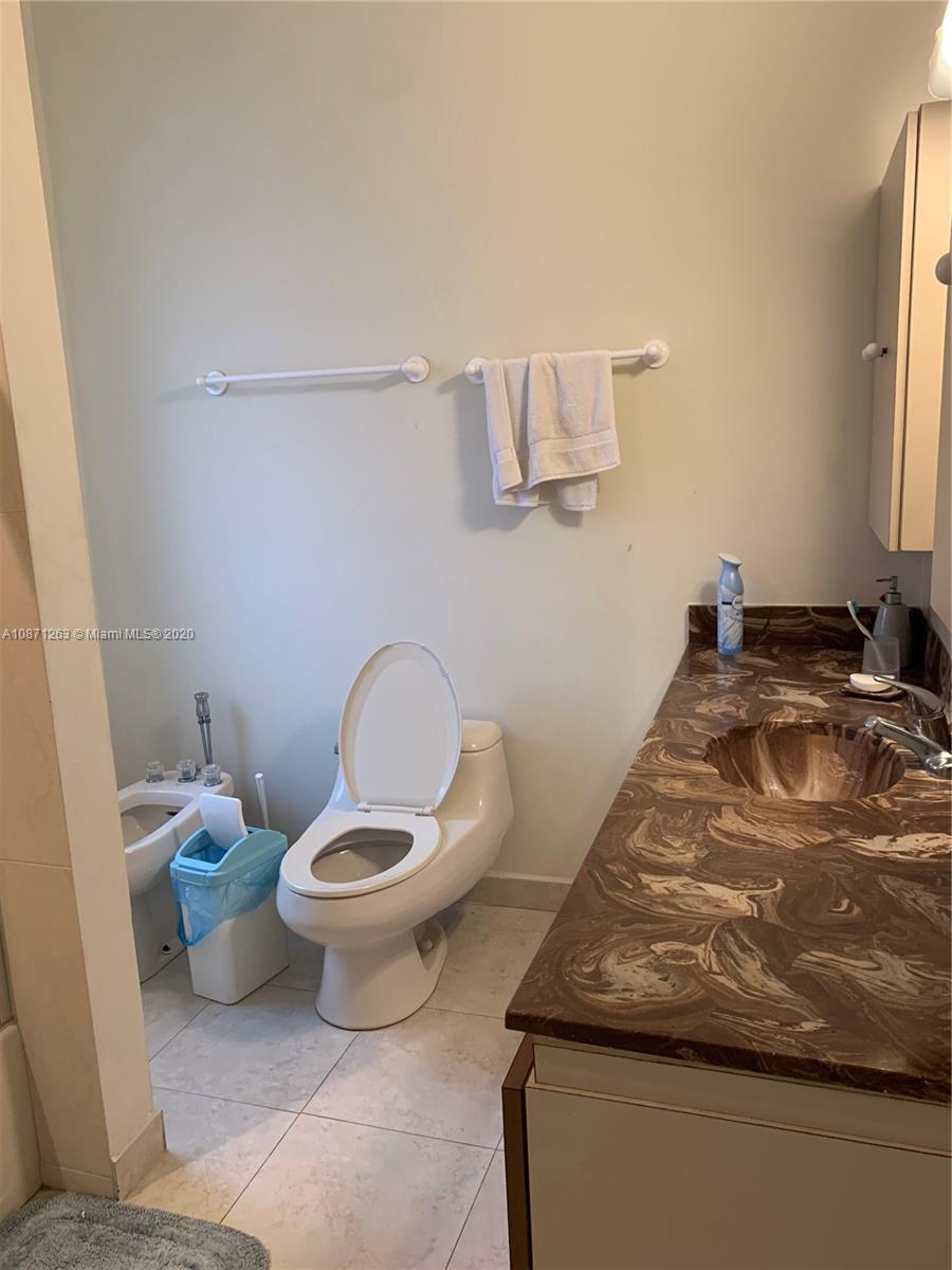 105 Southwest 22nd Road Miami, FL 33129 - Photo 15 of 26 a bathroom with a toilet and a mirror