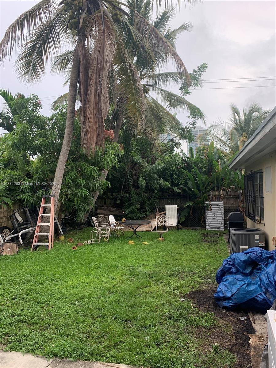 105 Southwest 22nd Road Miami, FL 33129 - Photo 6 of 26 a view of a backyard with a sitting area and slide