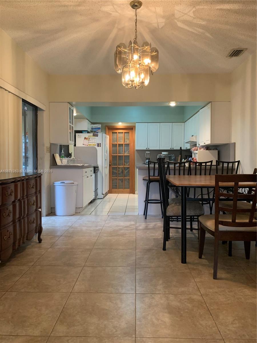 105 Southwest 22nd Road Miami, FL 33129 - Photo 10 of 26 a view of a dining room with furniture and chandelier