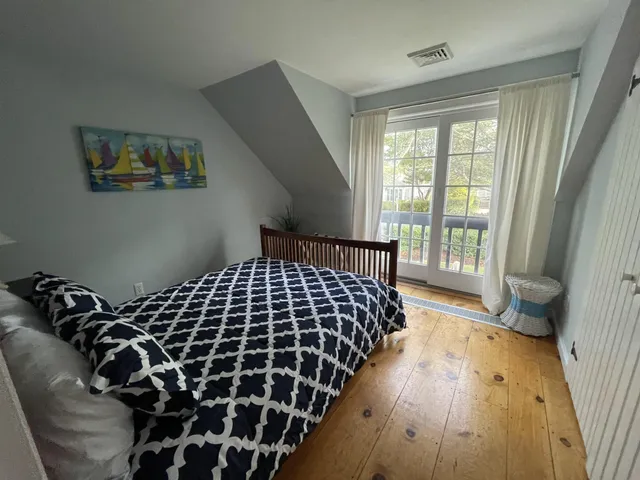 a bed sitting in a bedroom next to a window