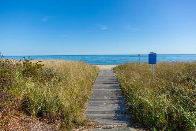 a view of an ocean with a floor to ceiling window
