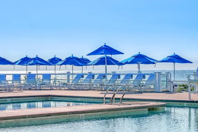 a view of lawn chairs under an umbrella