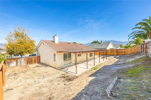 a view of a house with a snow in the background