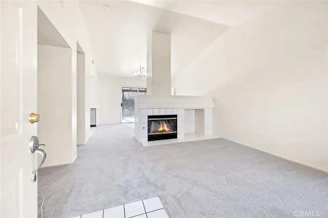 a view of an empty room with a fireplace
