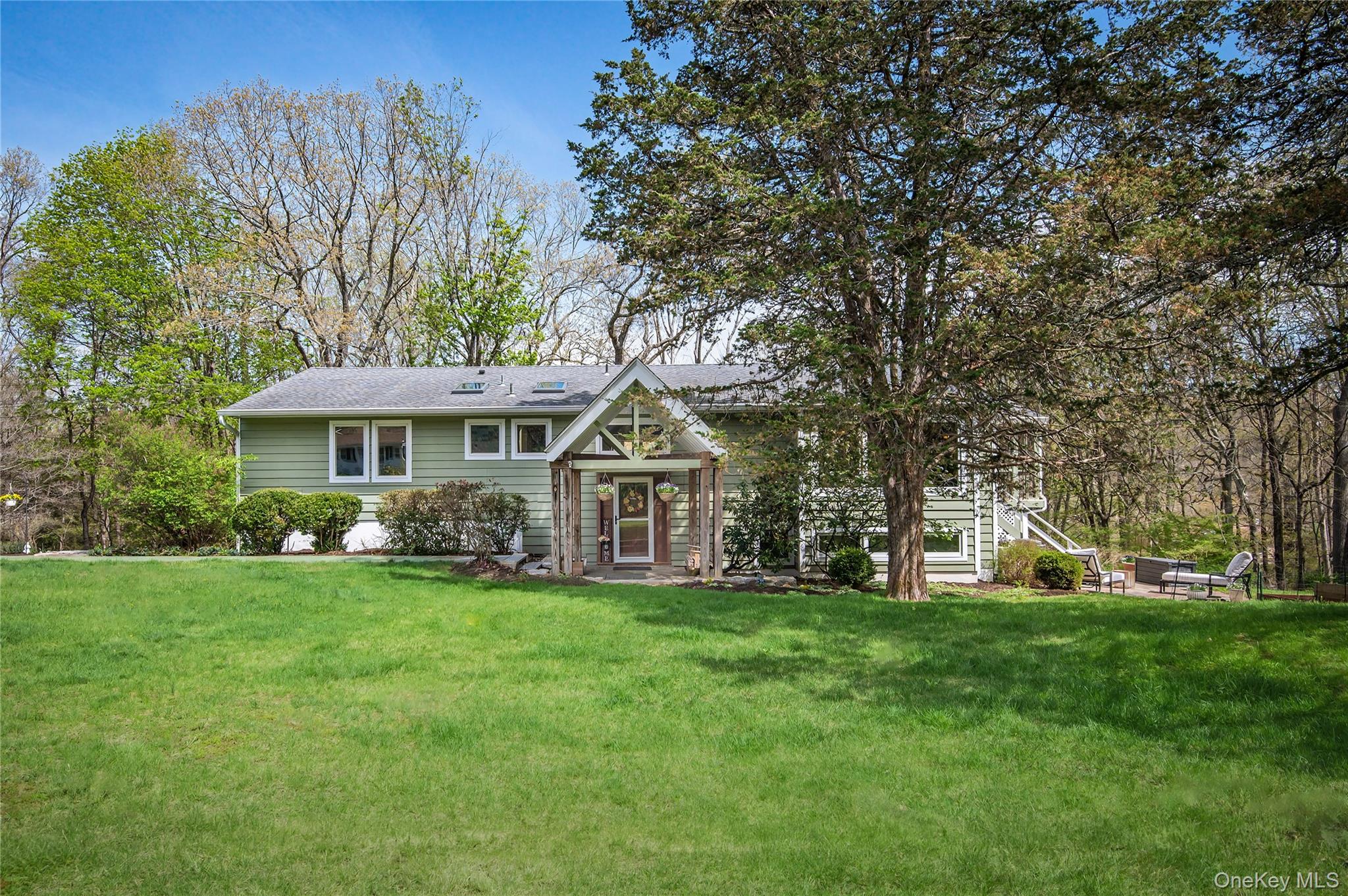 41 Cross Pond Road Pound Ridge, NY 10576 - Photo 1 of 41 a front view of a house with a garden