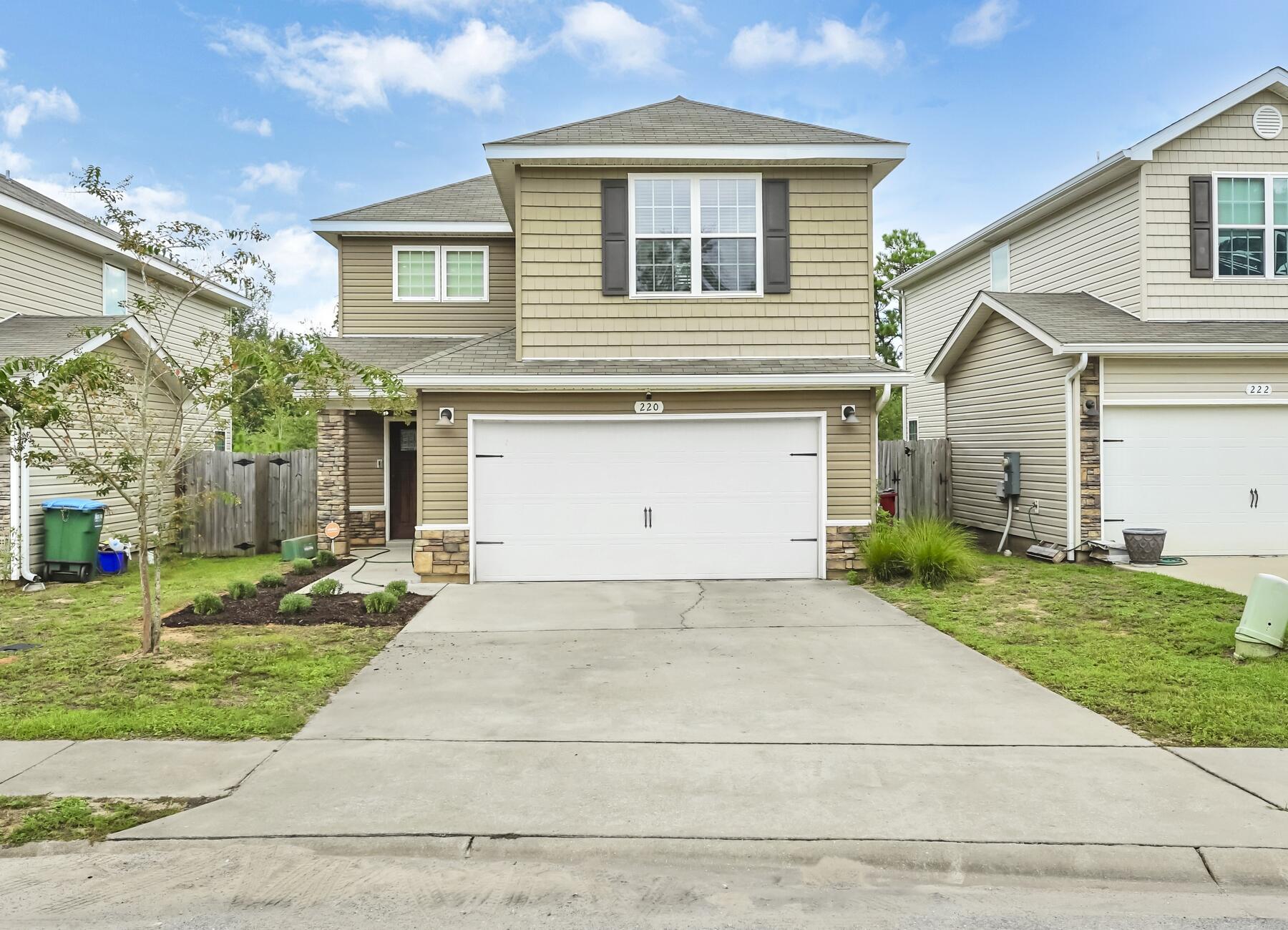 220 Wainwright Drive Crestview, FL 32539 - Photo 1 of 56 a front view of a house with a yard and a garage