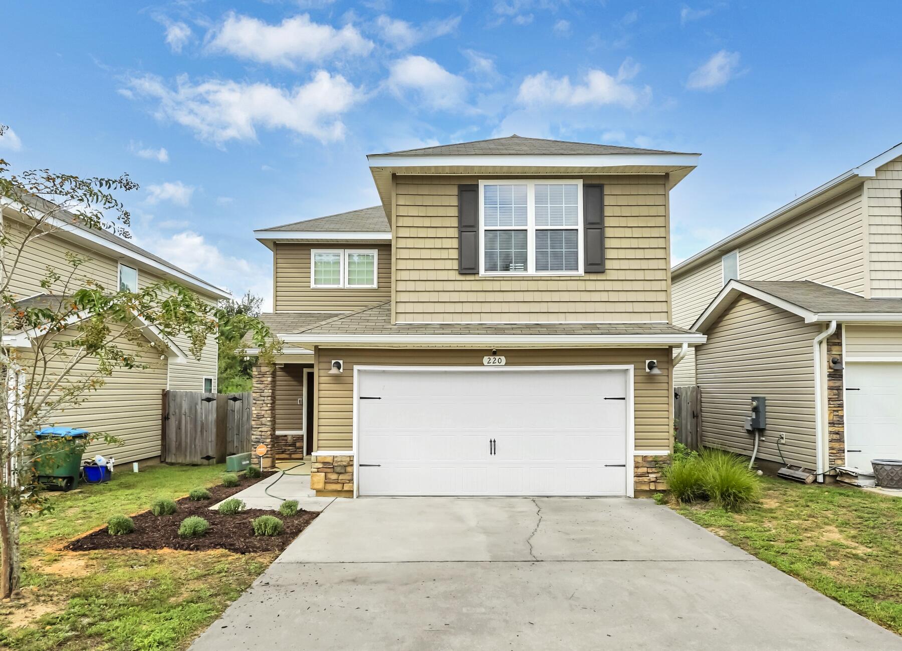 220 Wainwright Drive Crestview, FL 32539 - Photo 12 of 56 a front view of a house with a yard and garage