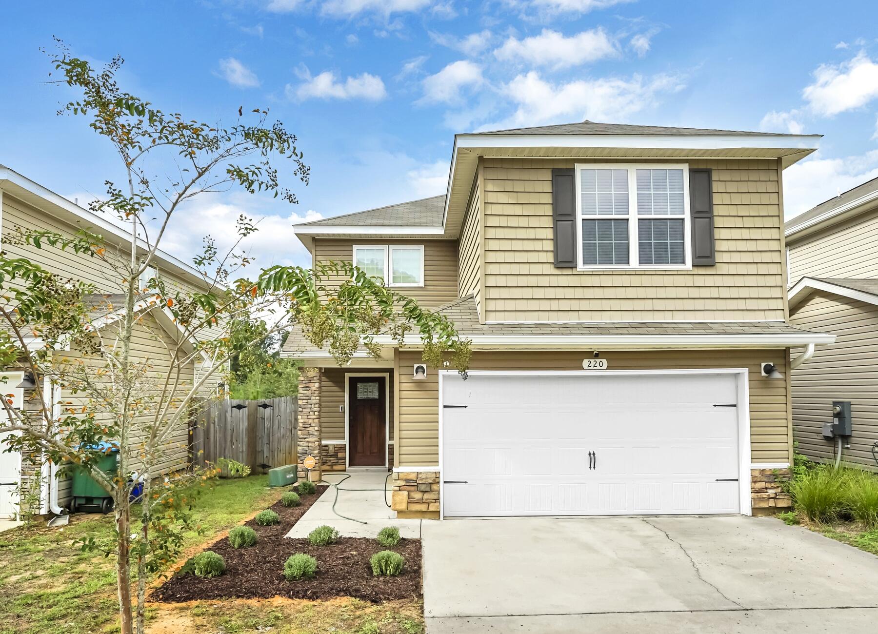 220 Wainwright Drive Crestview, FL 32539 - Photo 13 of 56 a front view of a house with garden