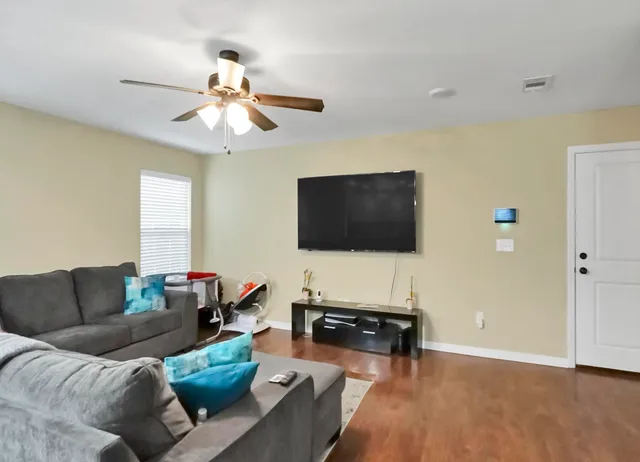 a living room with furniture and a flat screen tv