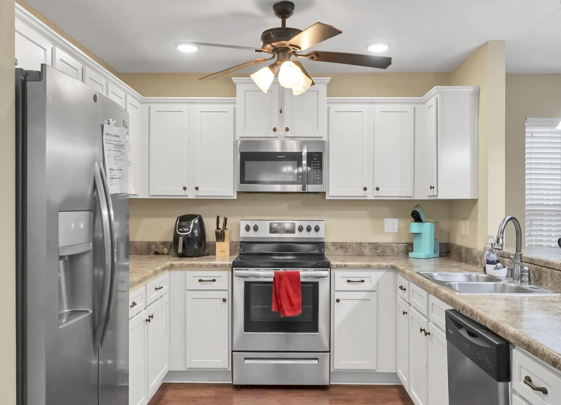 220 Wainwright Drive Crestview, FL 32539 - Photo 19 of 56 a kitchen with stainless steel appliances granite countertop a stove a sink and a refrigerator