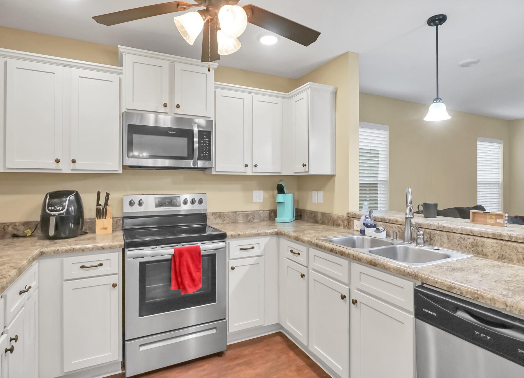 220 Wainwright Drive Crestview, FL 32539 - Photo 21 of 56 a kitchen with stainless steel appliances granite countertop a stove a sink and a microwave