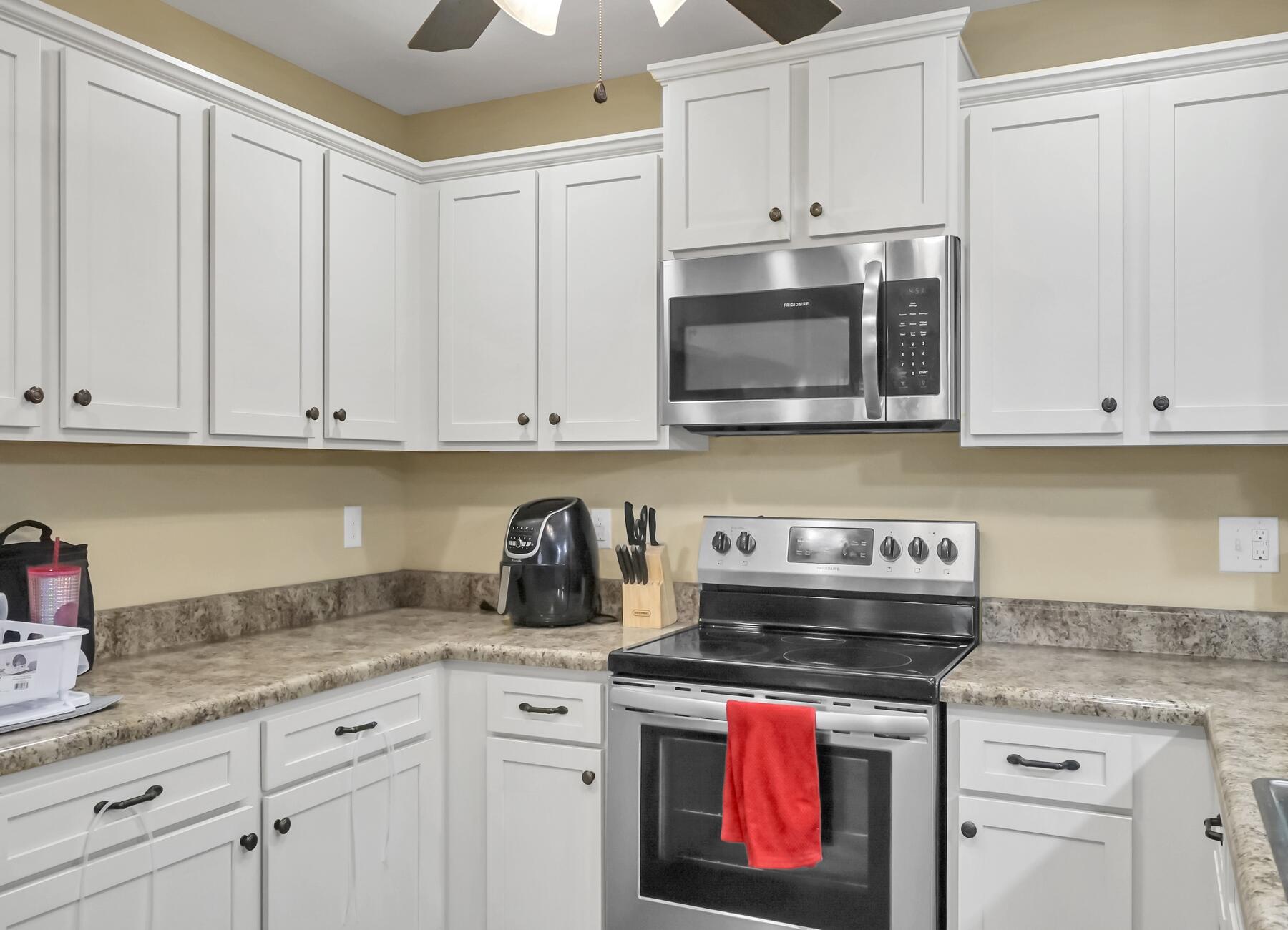 220 Wainwright Drive Crestview, FL 32539 - Photo 22 of 56 a kitchen with granite countertop white cabinets and stainless steel appliances