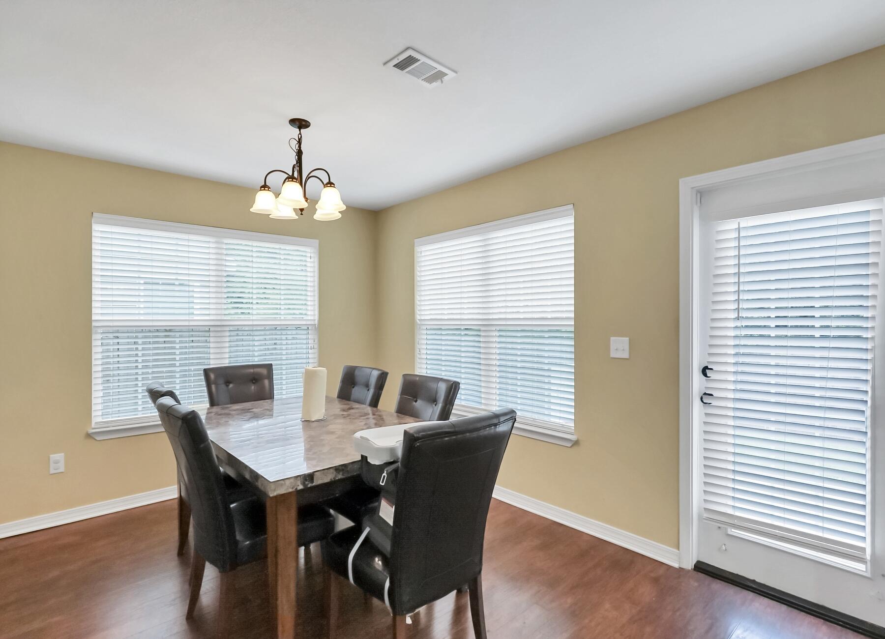 220 Wainwright Drive Crestview, FL 32539 - Photo 23 of 56 a view of a dining room with furniture window and wooden floor